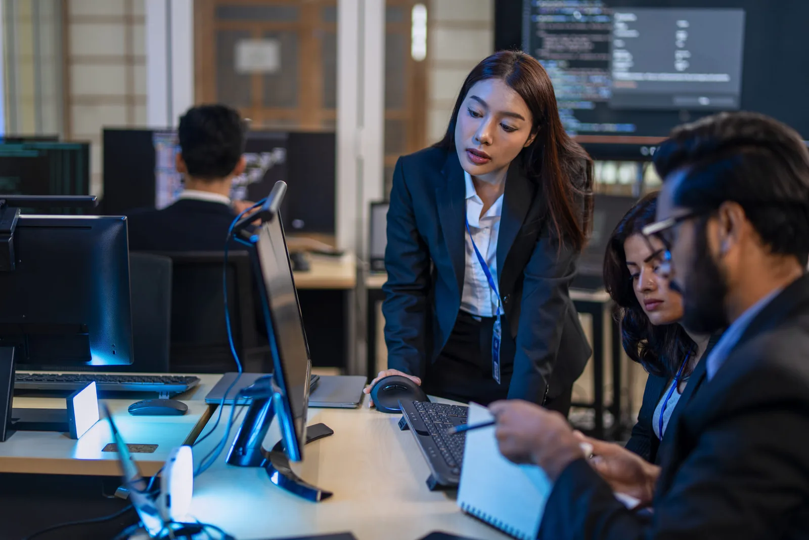 IT compliance team reviewing code and security standards in an office