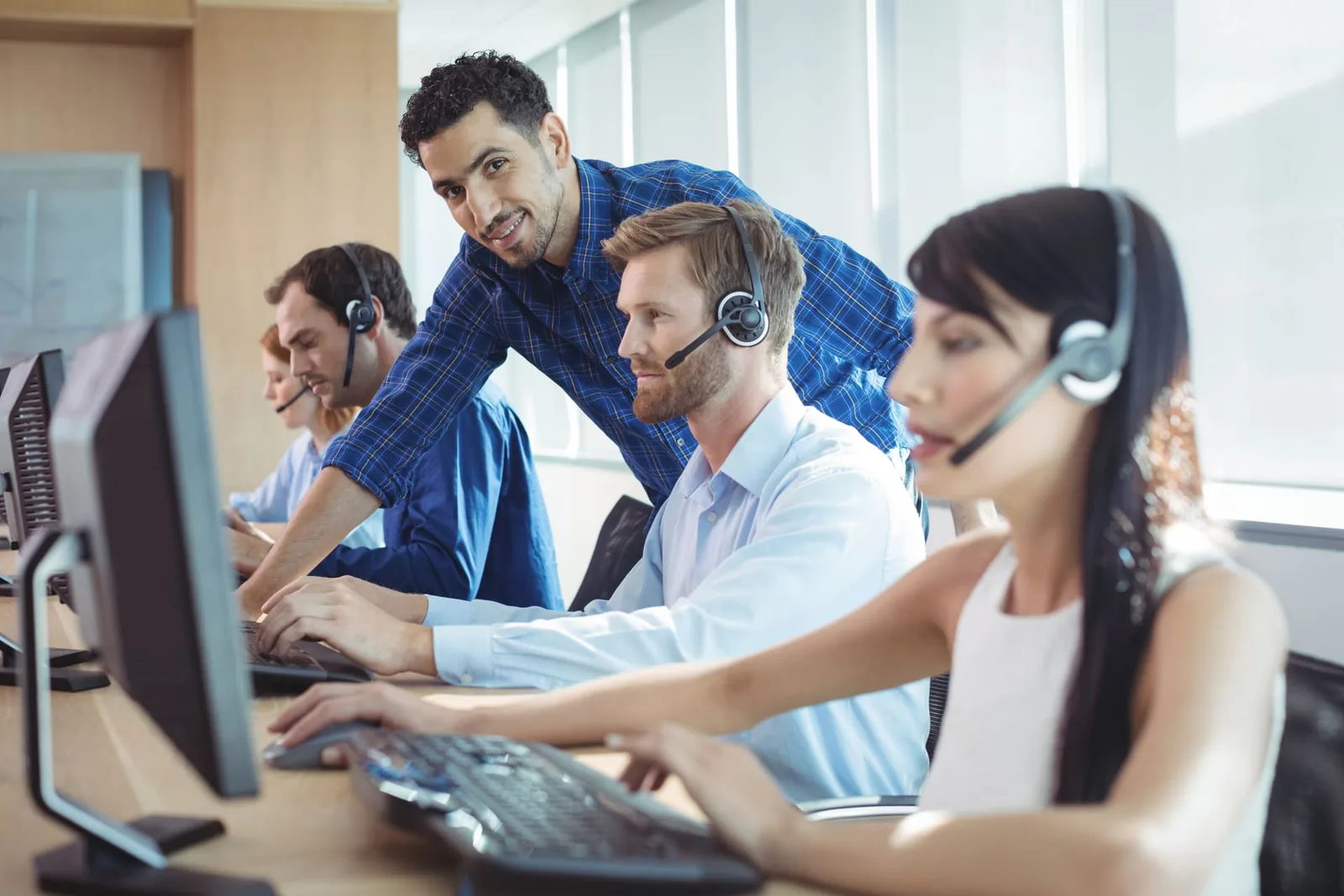 IT help desk support agent assisting a customer with a headset