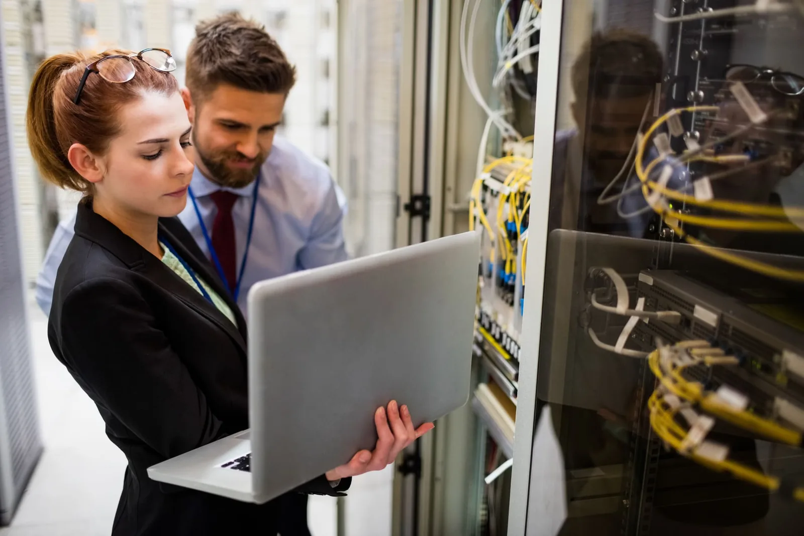 Network engineers working on servers with a laptop